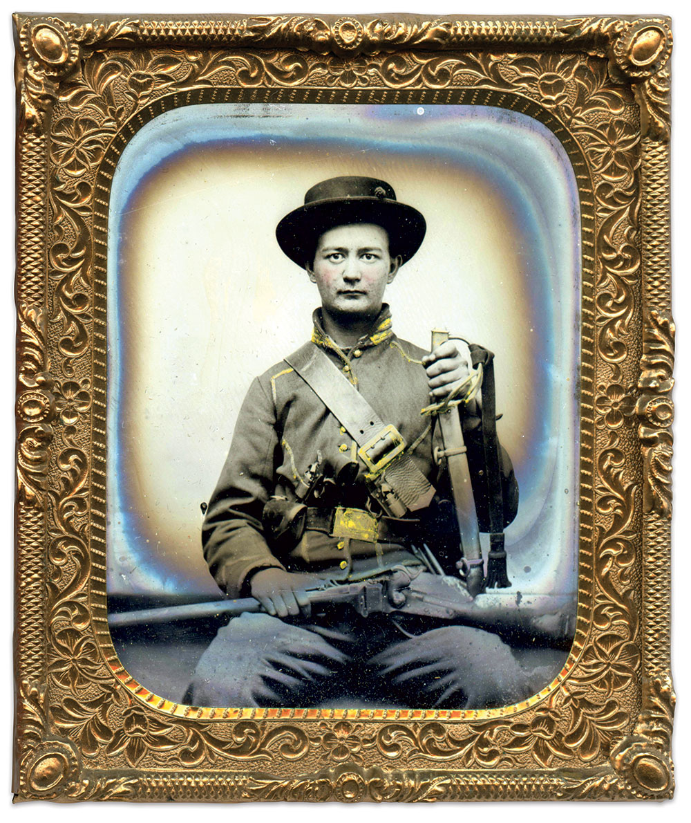 A Buckeye horse soldier poses with two Colt Army Model 1860 .44 caliber percussion six-shot revolvers and a Model 1859 Sharps percussion .52 caliber carbine with leather sling. Sixth-plate tintype attributed to a Huntsville, Ala., photographer. Paul Reeder Collection.